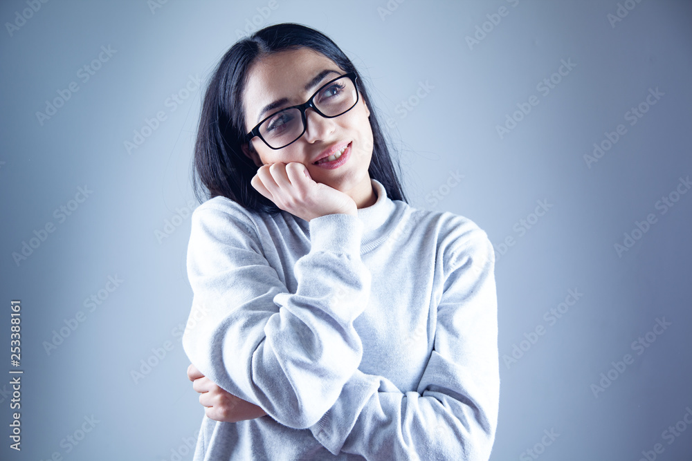 smiling young woman in gray background smiling young woman in gray background