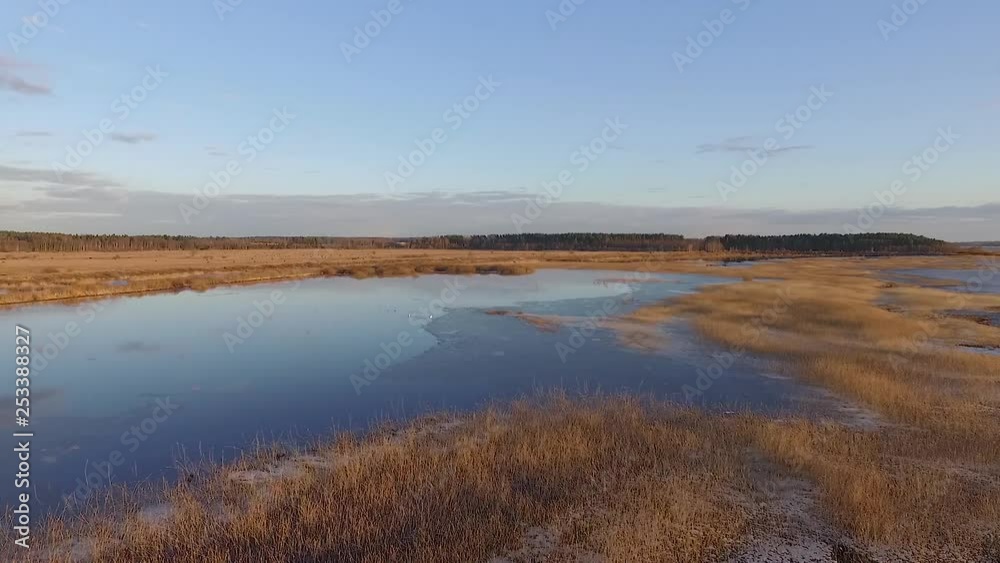 Calm lake Burtnieks with little ice and high water level in spring aerial view Calm lake Burtnieks with little ice and high water level in spring aerial view