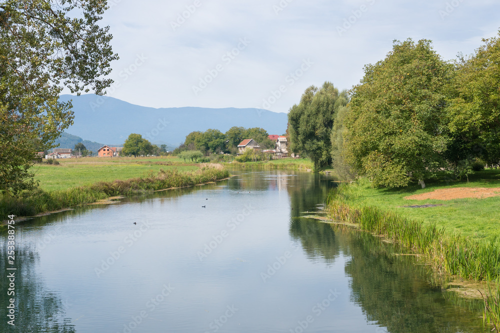 idyllic landscape view of riverbanks of gacka in central croatia