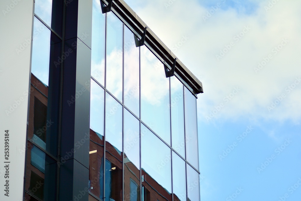 Sky reflected in a modern building glass facade Sky reflected in a modern building glass facade