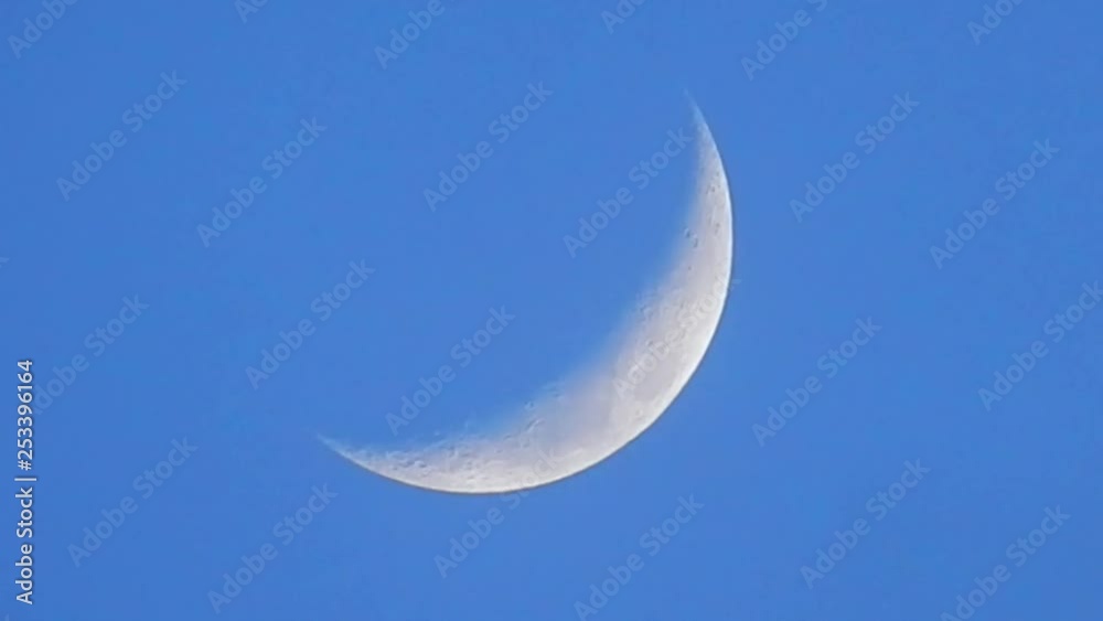 Close up view of crescent moon texture with craters. Faded misty opaque clouds passing through shot passing surface. Close up view of crescent moon texture with craters. Faded misty opaque clouds passing through shot passing surface.
