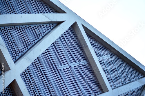 Abstract image of looking up at modern glass and concrete building. Architectural exterior detail of office building. 