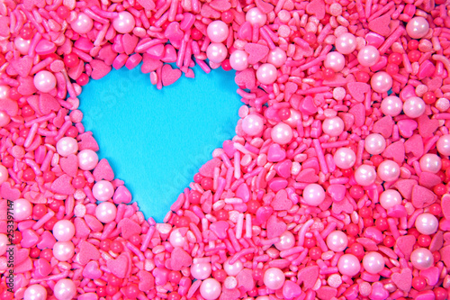 Full frame pink heart sprinkles and a heart form,