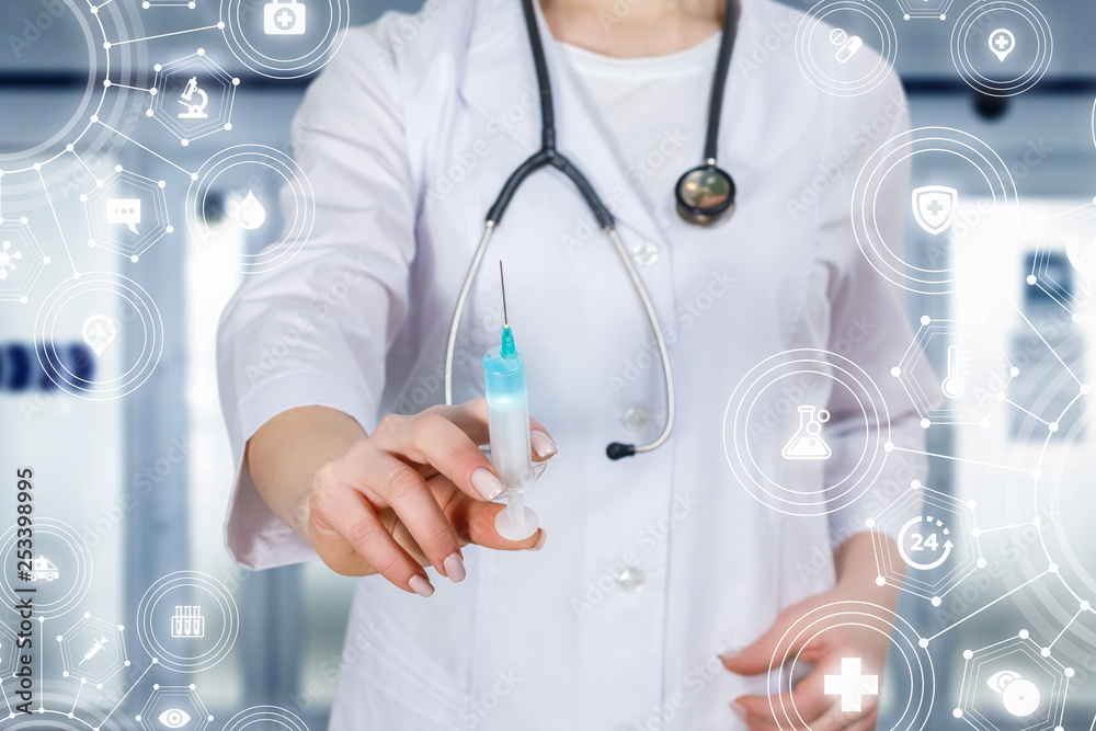 A doctor holding a syringe with some substance. A doctor holding a syringe with some substance.
