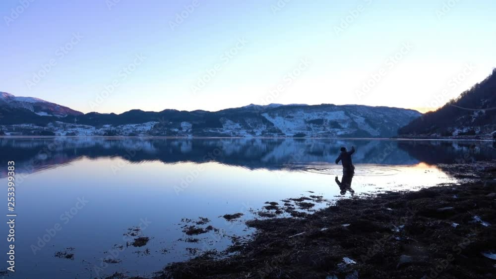 Fly Fishing cast in Norwegian fjord, reflection in water and mountains in the background. Slow motion. Fly Fishing cast in Norwegian fjord, reflection in water and mountains in the background. Slow motion.