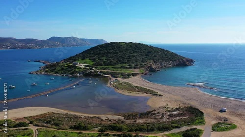 Aerial drone video of famous small islet with picturesque chapel of Agios Nikolaos and small marina, Anavissos area, Attica, Greece photo