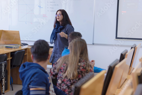 Female professor explain to students and interact with them in t