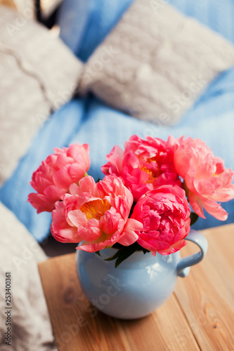 coral peony in blue pitcher