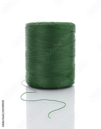 spool of green string on white