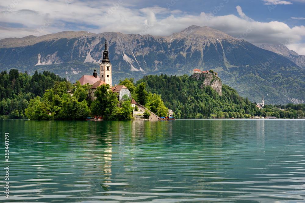 Assumption of Mary pilgrimage church Beld Island Lake Bled with Bled castle on cliff and St Martin church Sol massive of Karavanke mountains Slovenia