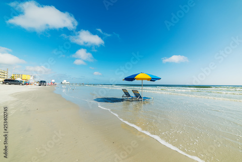 Beach chairs and parasol on the sand in Daytona Beach shore