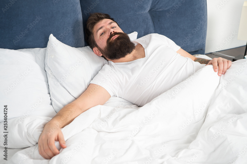 Sleep disorders concept. Man bearded hipster having problems with sleep. Guy lying in bed try to relax and fall asleep. Relaxation techniques. Violations of sleep and wakefulness. What a long night Sleep disorders concept. Man bearded hipster having problems with sleep. Guy lying in bed try to relax and fall asleep. Relaxation techniques. Violations of sleep and wakefulness. What a long night