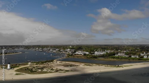 Drone shot of Martha's Vineyard's beach on a bright sunny day with clouds rolling by and a lighthouse. photo