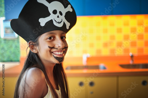 Portrait of young girl dressed up as a pirate.