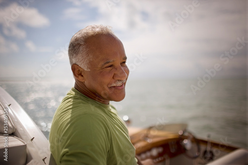 Mature adult man sitting on a boat.