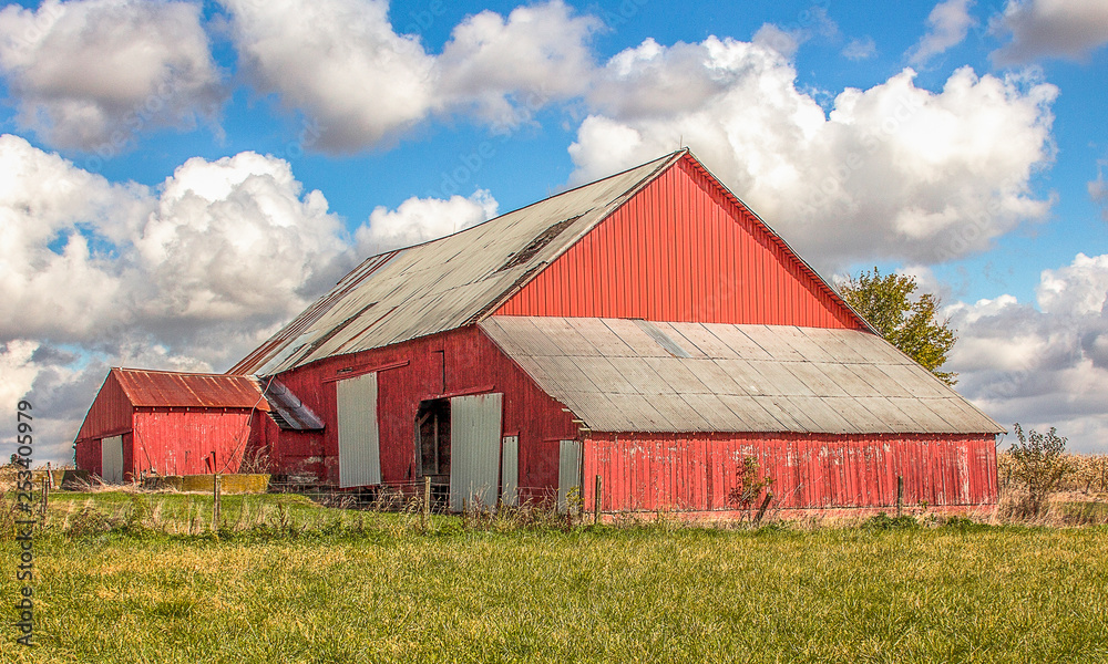 A beautiful red barn and clouds and a gorgeous autumn day. A beautiful red barn and clouds and a gorgeous autumn day.