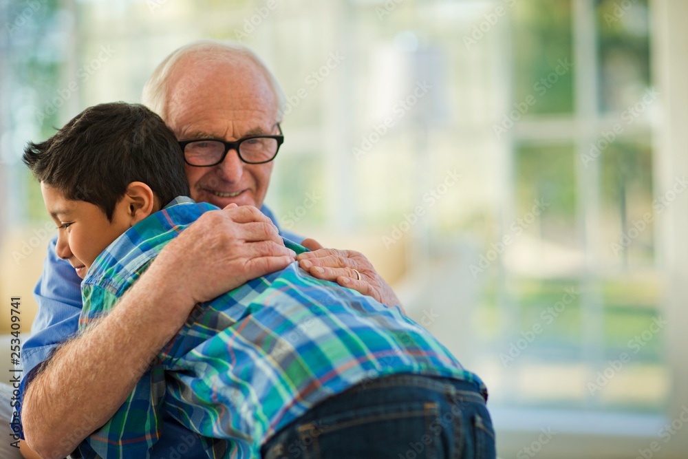 Smiling senior man embracing his young grandson. Smiling senior man embracing his young grandson.