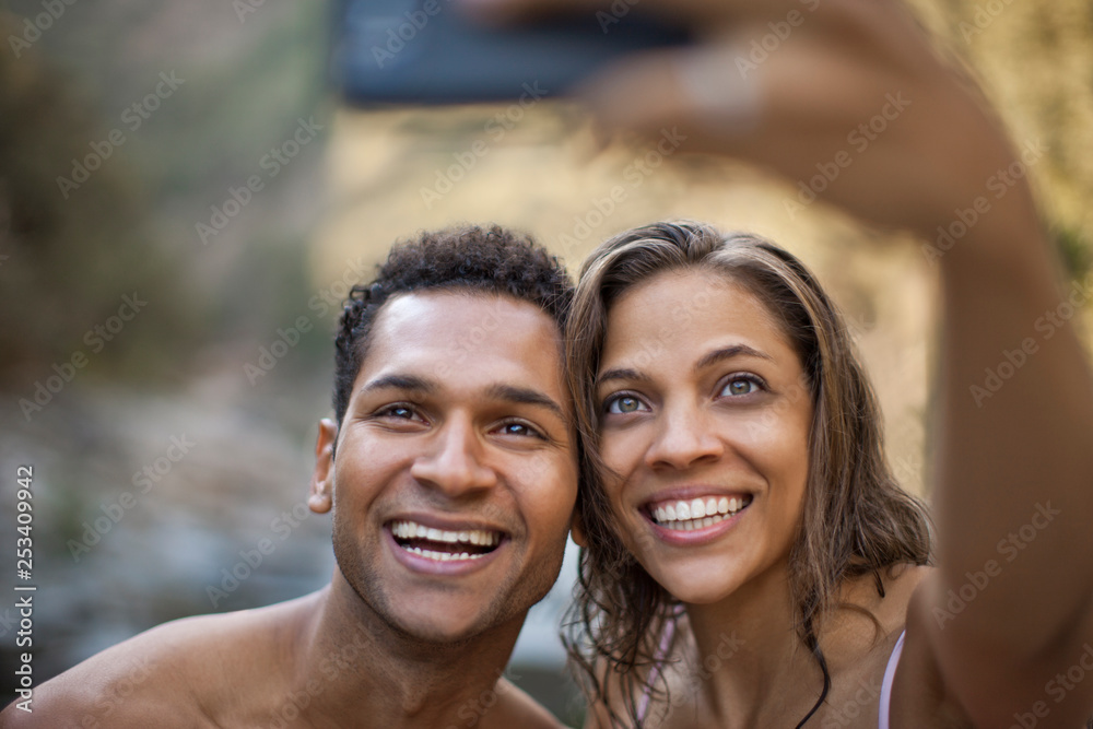 Smiling young couple posing for a self portrait. Smiling young couple posing for a self portrait.
