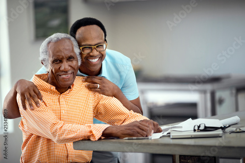 Father and son do taxes together. photo