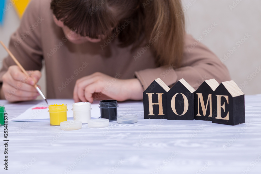 Child making homemade greeting card. Little girl paints heart on homemade greeting card as gift for Mother Day. Traditional play concept. Arts concept