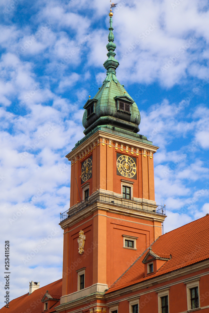 Clock Tower of the Royal Palace in Warsaw, Poland on the background of blue sky with clouds