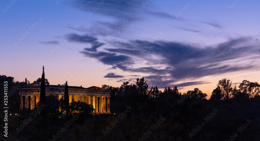 Athens Greece. Hephaestus temple illuminated, at sunset, blue color sky