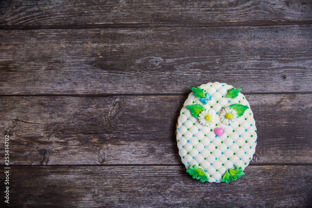 Round handpainted gingerbread on wooden background. White owl. Flat lay. Copy space. Sweet dessert as a gift for women's day on 8 March Round handpainted gingerbread on wooden background. White owl. Flat lay. Copy space. Sweet dessert as a gift for women's day on 8 March