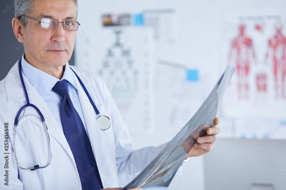 Male doctor writes notes on the clipboard in the hospital Male doctor writes notes on the clipboard in the hospital