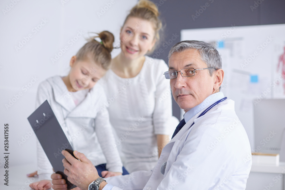 Little girl with her mother at a doctor on consultation