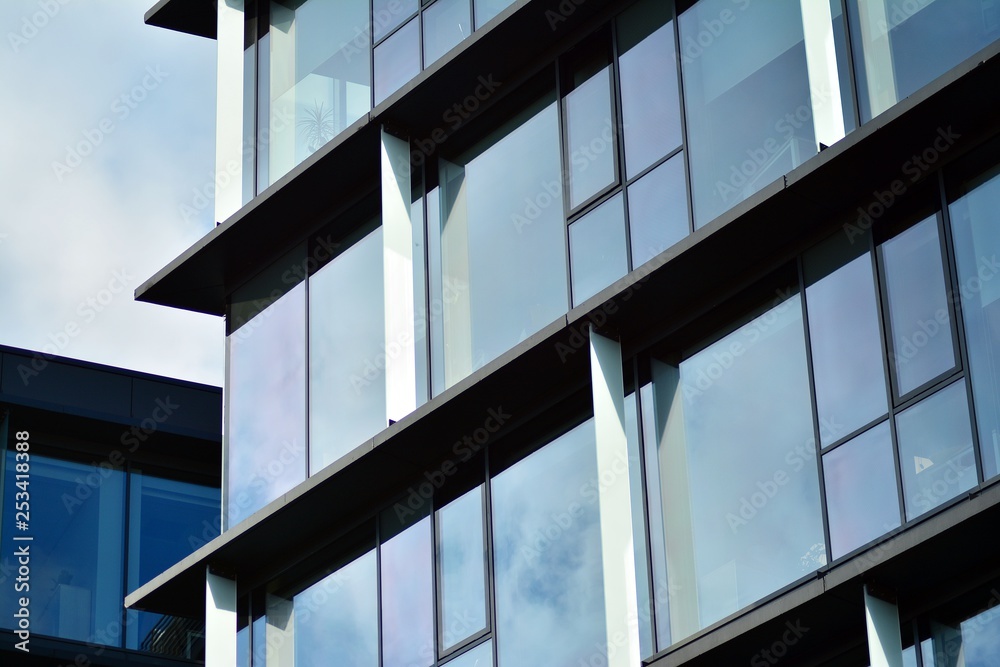 Sky reflected in a modern building glass facade Sky reflected in a modern building glass facade