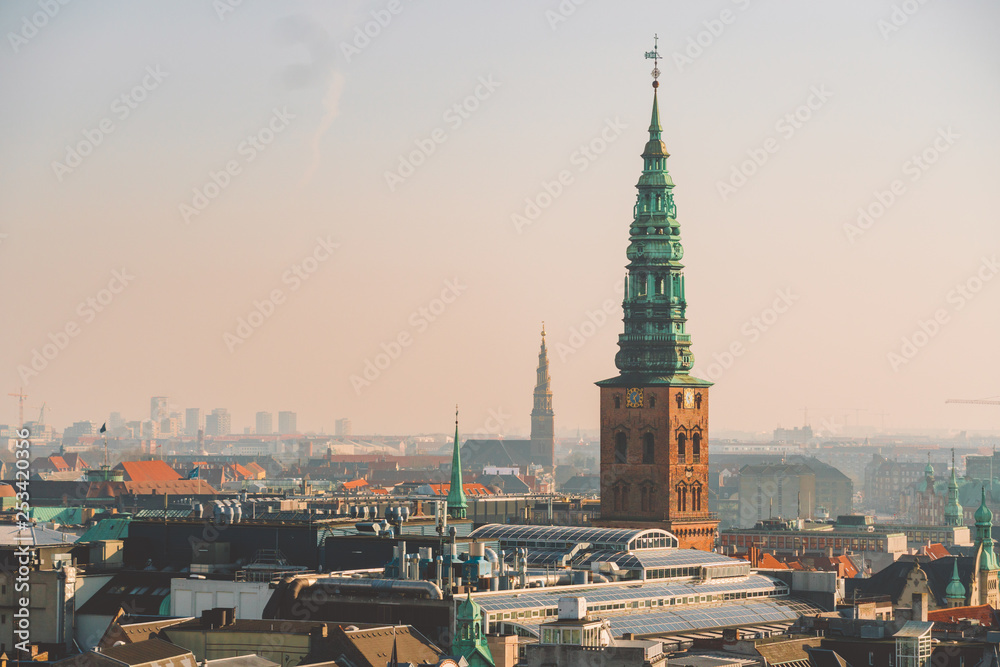 February 18, 2019. Denmark Copenhagen. Panoramic top view of the city center from a high point. Round Rundetaarn Tower February 18, 2019. Denmark Copenhagen. Panoramic top view of the city center from a high point. Round Rundetaarn Tower
