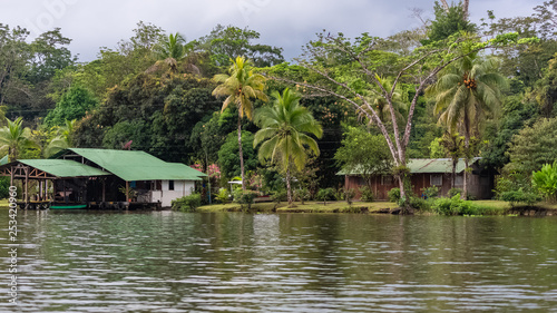 Costa Rica, typical houses and boat on the river, in Tortuguero, wildlife in the mangrove