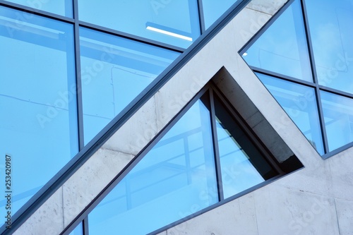 Abstract image of looking up at modern glass and concrete building. Architectural exterior detail of office building. 