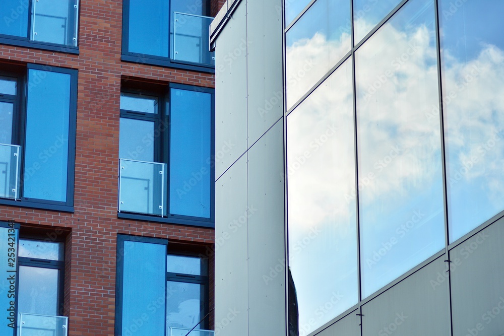Obraz premium Sky reflected in a modern building glass facade