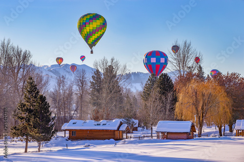 Winter rural landscape with hot air balloons   photo