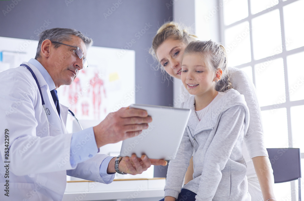 Fototapeta premium Portrait of a cute little girl and her doctor at hospital