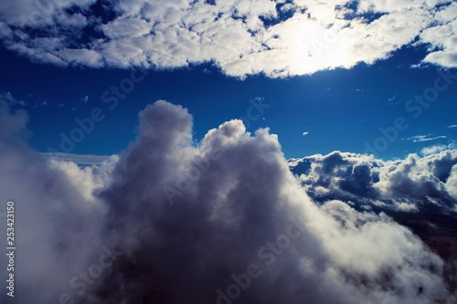 Fototapeta Naklejka Na Ścianę i Meble -  Sun above clouds with a blue sky. Fantastic landscape. Peace, Freedom, overcoming, inspirational, God. Great sky view! Drone flying above clouds. Sunrise view. 