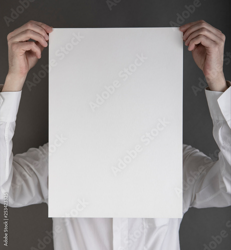 A man holding white poster