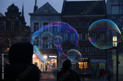 crowd of people at night in city playing with bubbles