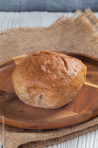 close up of white bread bun on plate