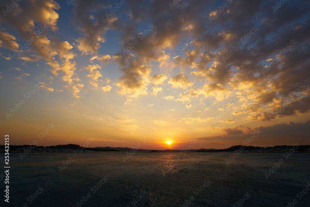 Empty concrete cement floor with beautiful and dramatic golden hour  sunset sky .