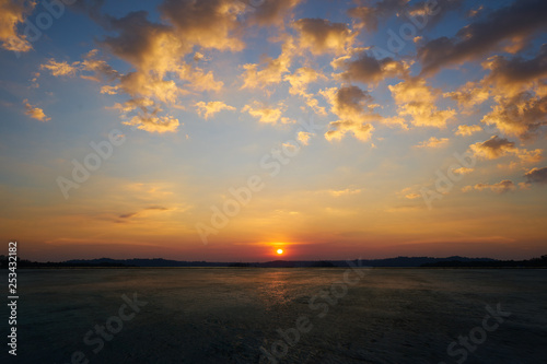 Fototapeta Naklejka Na Ścianę i Meble -  Empty concrete cement floor with beautiful and dramatic golden hour  sunset sky .