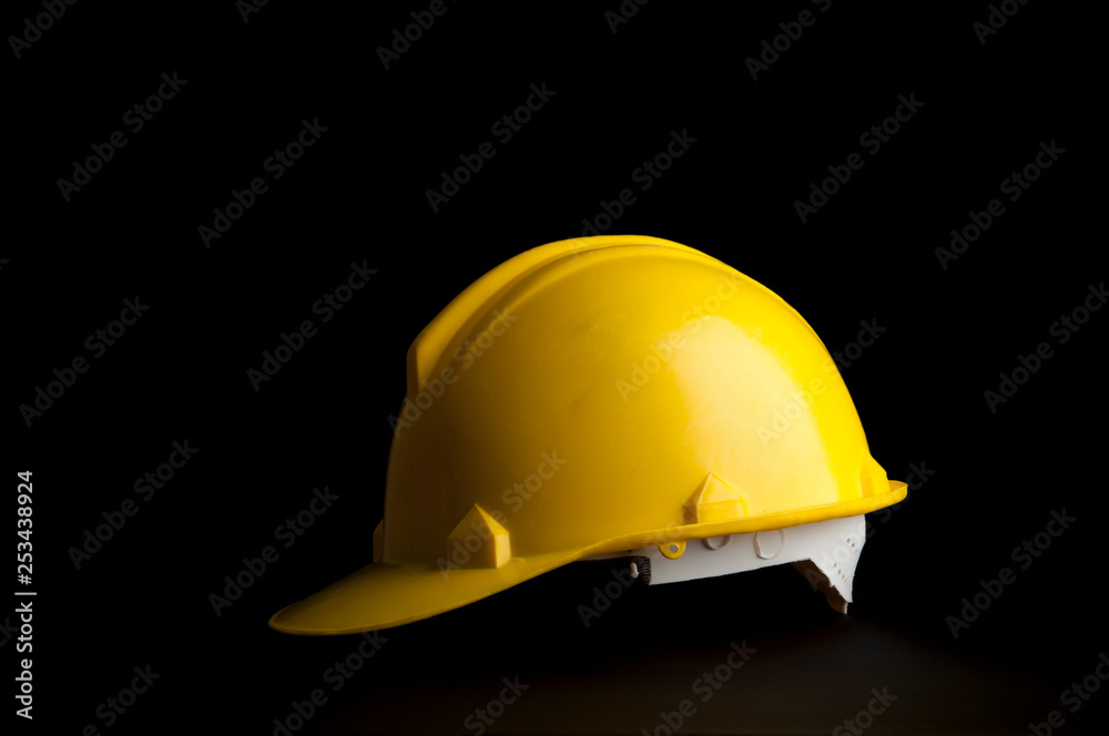 Yellow safety Worker and Engineer helmet on black background. Yellow safety Worker and Engineer helmet on black background.