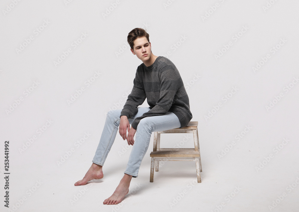 stylish fashion man model sitting on the chair 