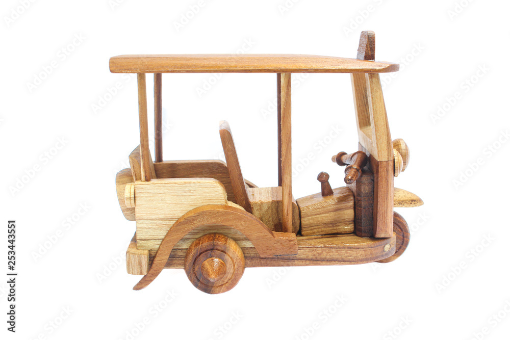 Fototapeta premium Wooden Tuk Tuk Taxi model. Three-Wheels on isolated photo