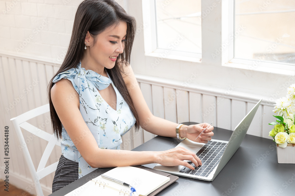 Freelancer business woman using computer laptop and credit cart to shopping online in cafe. Freelancer business woman using computer laptop and credit cart to shopping online in cafe.