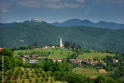 View of Church of the Holy Cross in Kojsko and Sveta Goro Holy Mountain with Basilica of the Assumption of Mary from Smartno Brda Slovenia photo