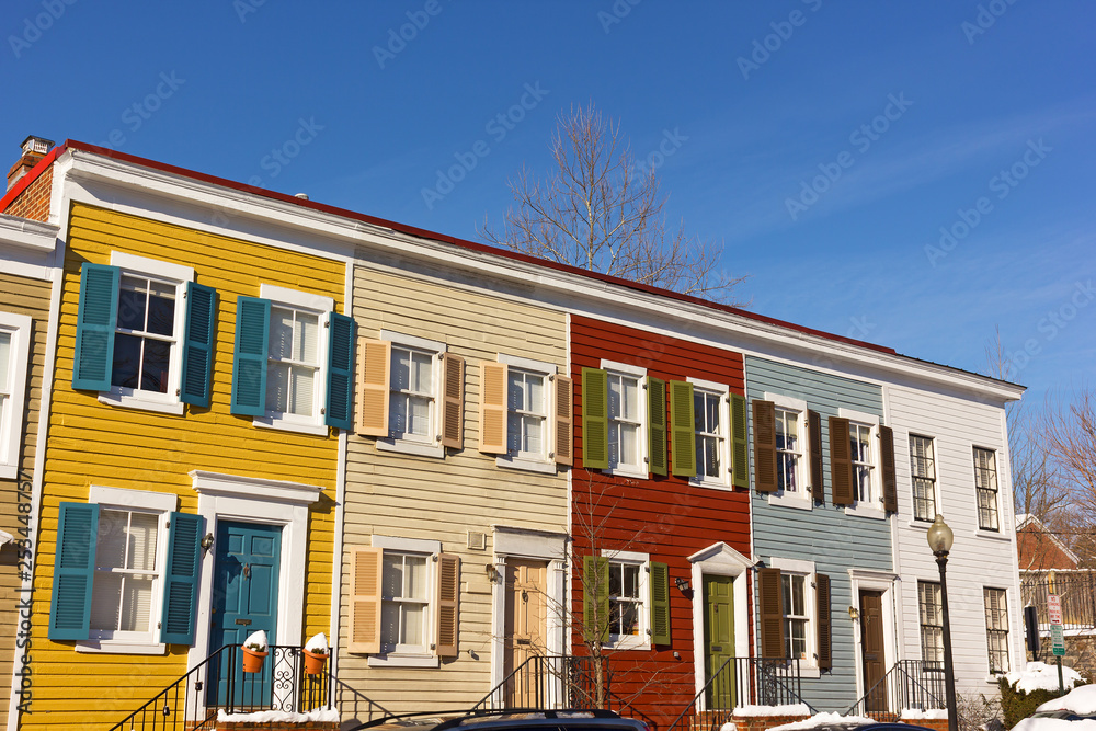 Historic row houses of Georgetown suburb in winter in Washington DC, USA. Colorful townhouses on a bright winter morning.
