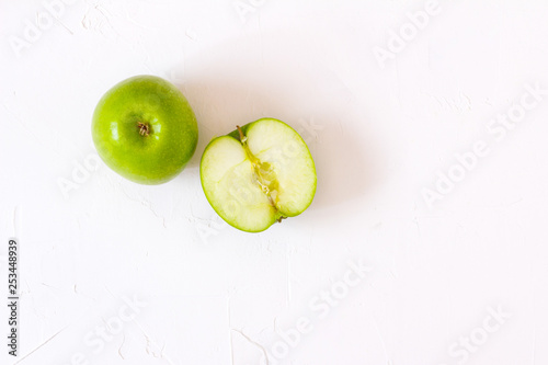 Green Apples on white table.