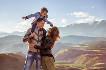 Happy family with son in mountains